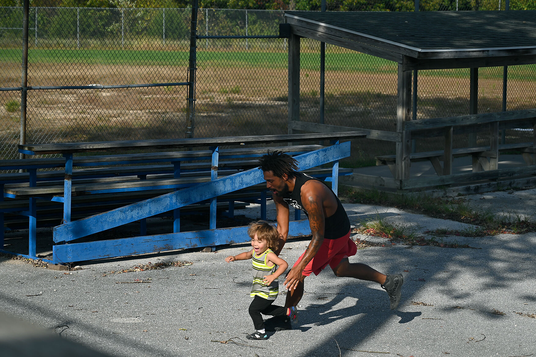 Tanner Cassil catches his son Isaiah Cassil, 2, while his team was kicking